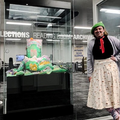 Yukkin stands next to their sculpture, "Croaking Bags"